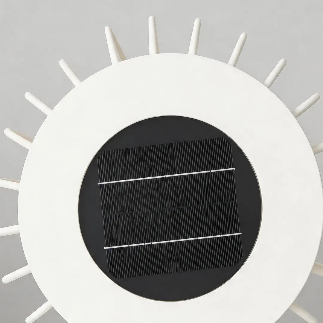 Close-up of the round solar panel on top of a solar garden lantern.