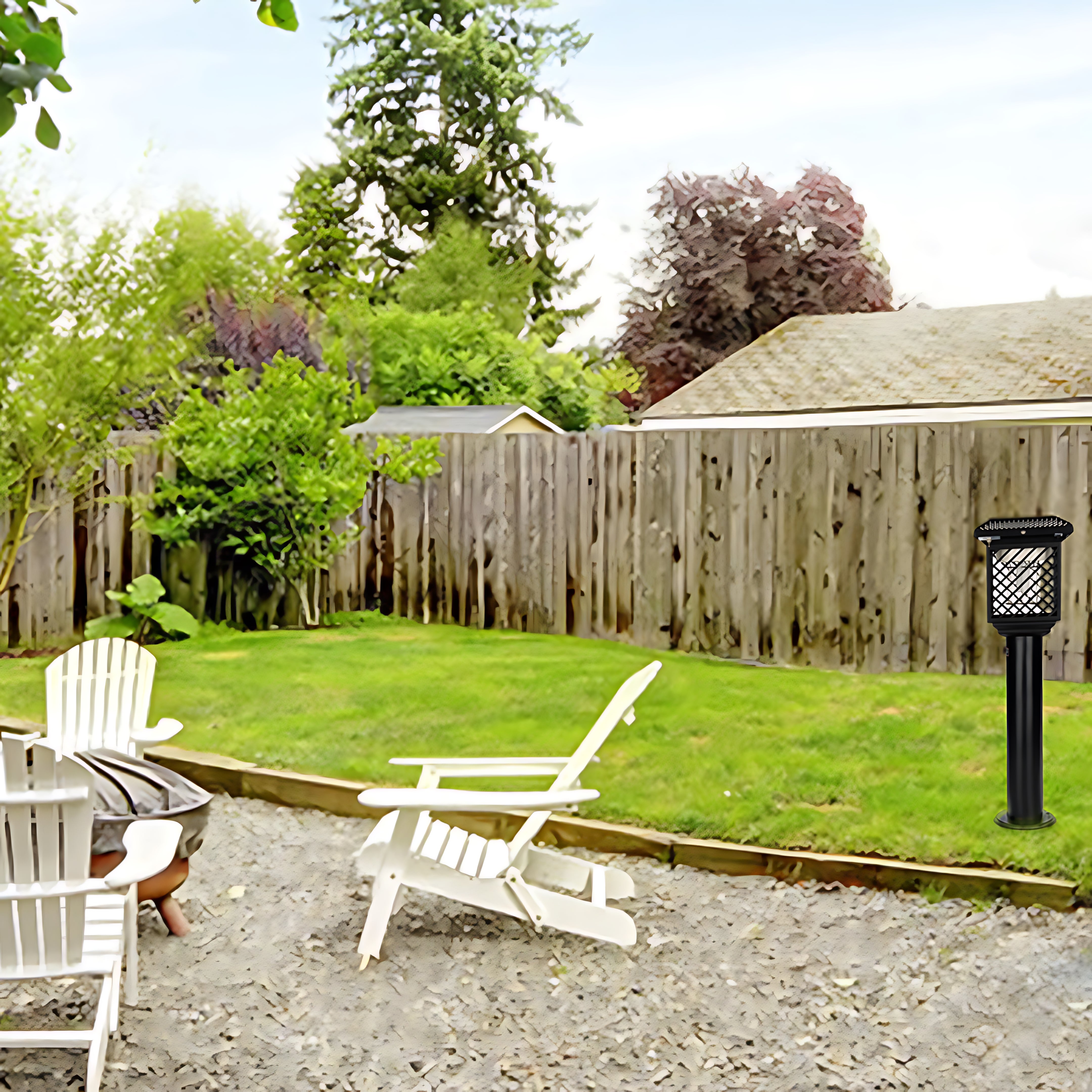 Solar garden light installed in residential backyard setting with lawn chairs and wooden fence