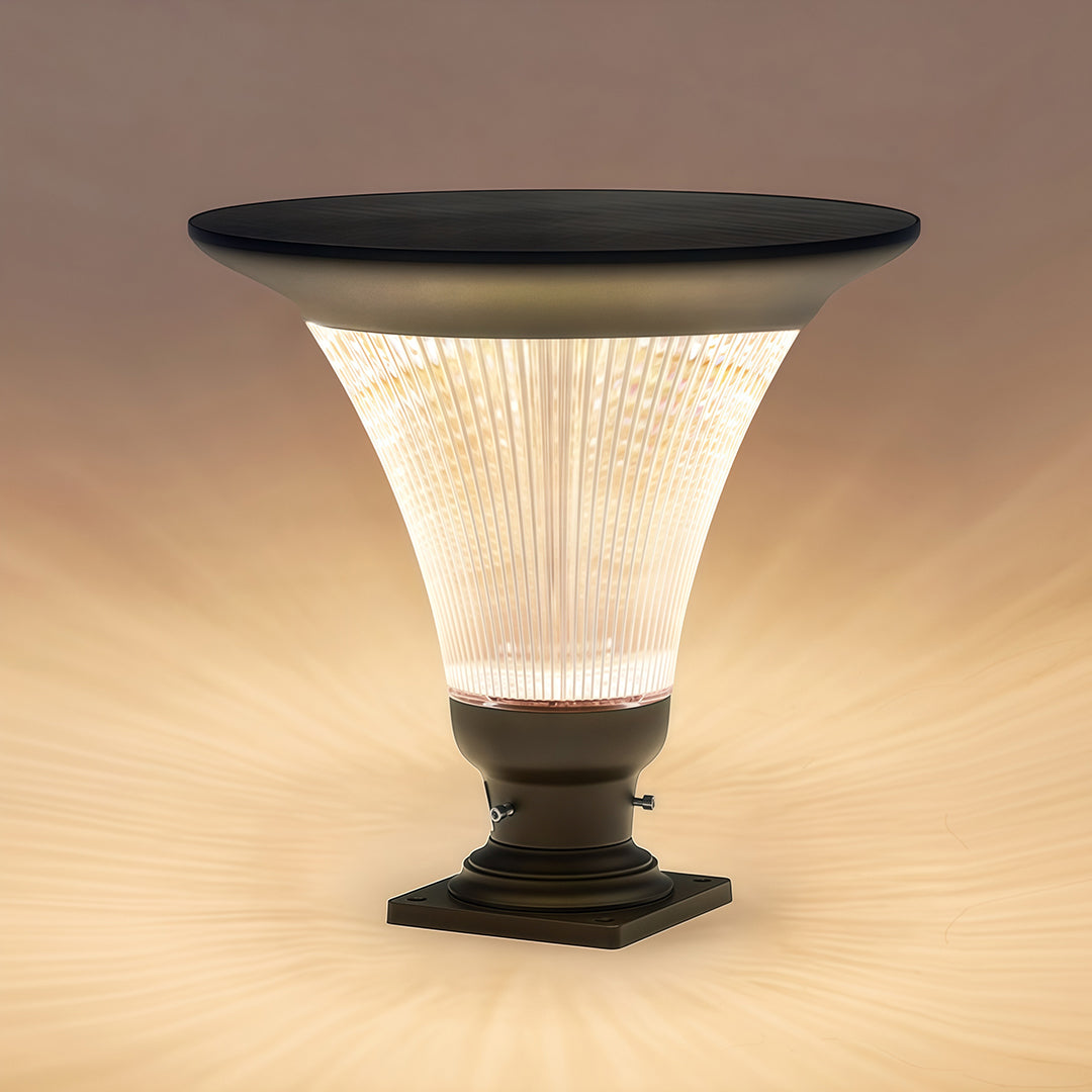 Solar-powered garden light pillar illuminating a floral pathway at night.