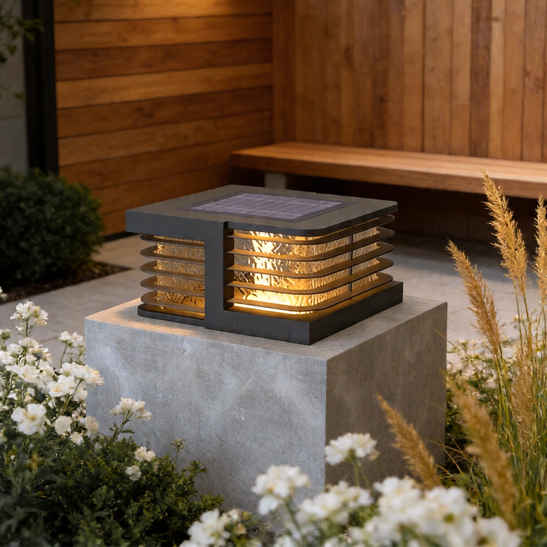 Solar gate pillar lights installed on concrete garden wall with warm decorative outdoor illumination.