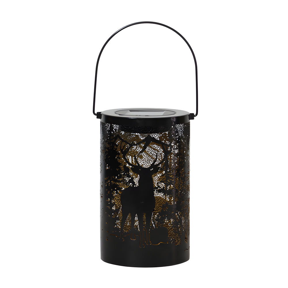 Solar hollow out lantern with deer and tree cut-outs, hanging by its handle.