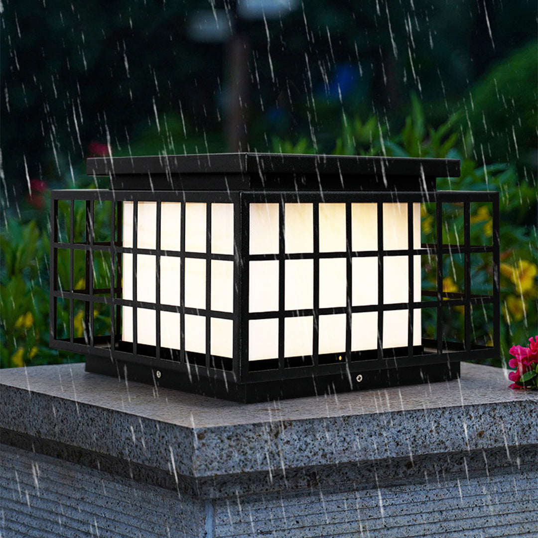 Solar-powered Japanese garden lantern with classic pagoda-style design providing ambient lighting in lush green landscape