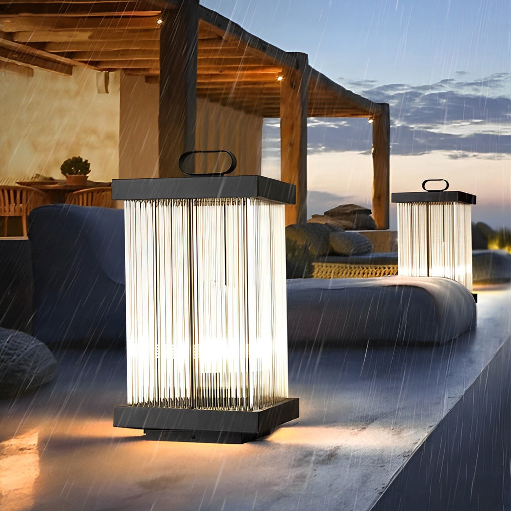 Solar lantern glowing beside outdoor lounge area during evening.