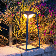 Solar-powered lantern illuminating vibrant tropical garden plants with warm evening glow
