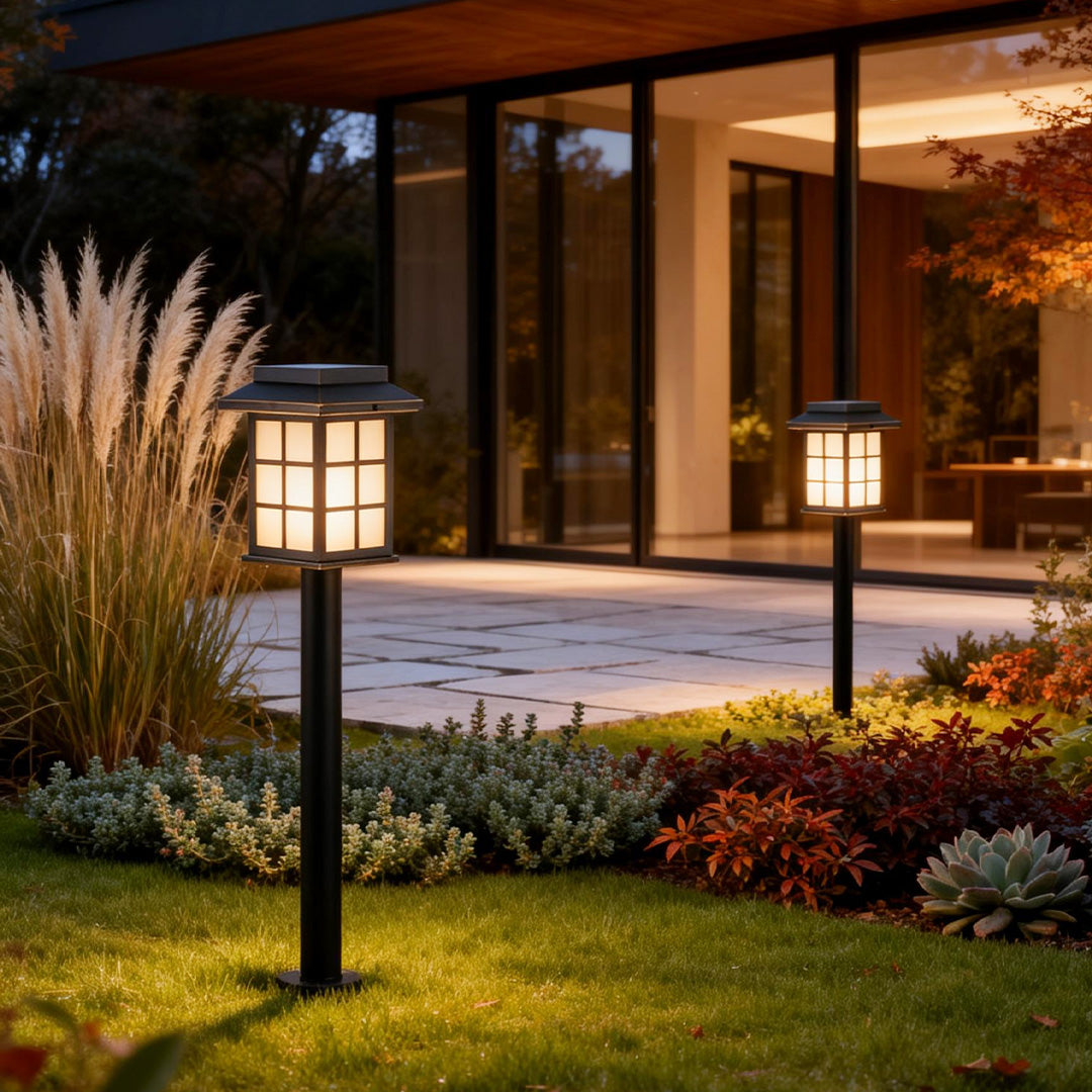 Solar led path lights installed along a modern garden walkway, providing warm illumination for landscaping and pathways at night.