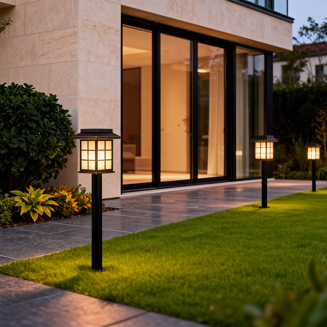 Outdoor solar led path lights lighting a curved lawn path near a contemporary home, creating safe and decorative night guidance.