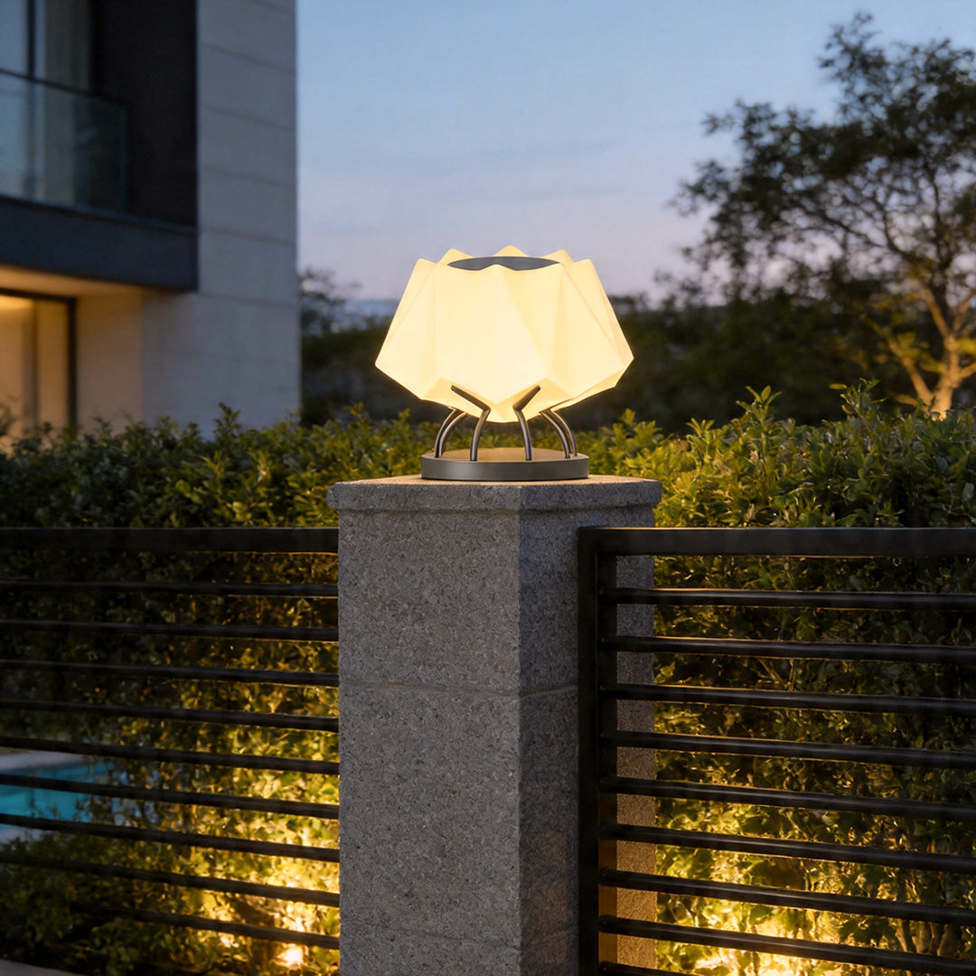 Solar led pillar lights installed on modern concrete fence post with warm decorative outdoor glow.