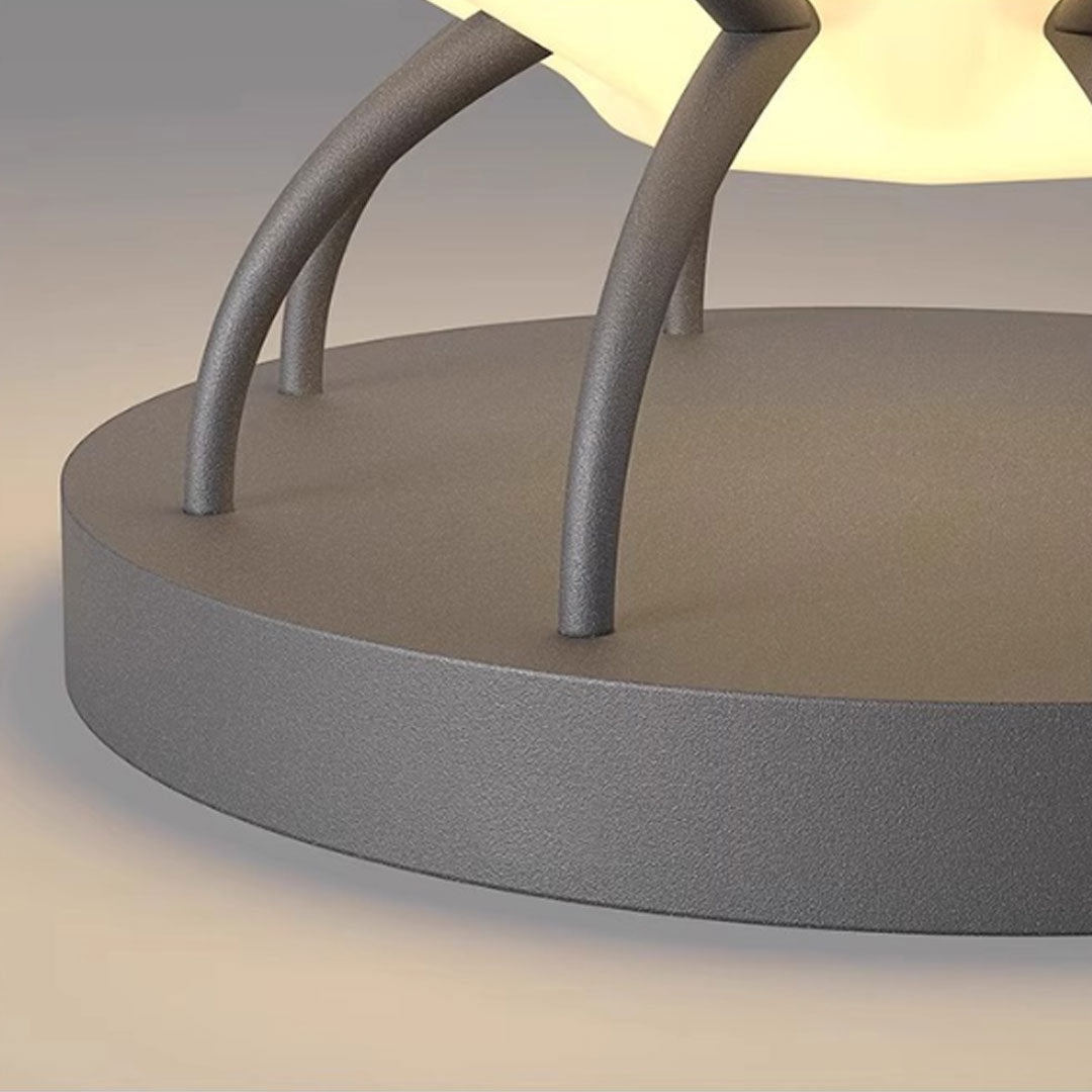Close-up detail of solar led pillar lights showing curved metal supports and textured base.