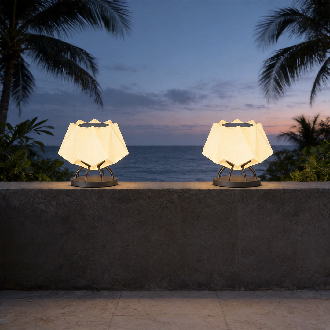 Solar led pillar lights illuminating seaside outdoor wall with elegant warm evening lighting design.
