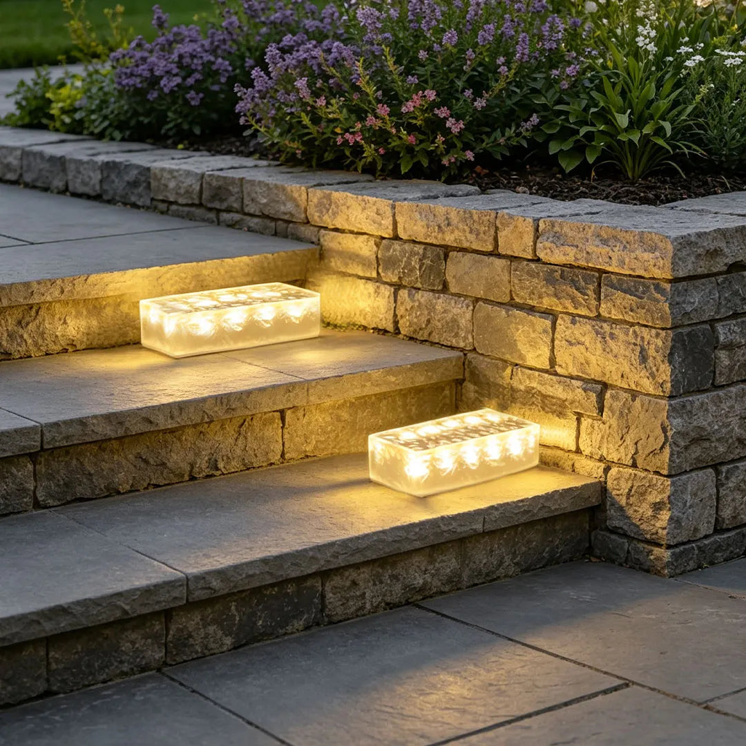 Solar LED step lights installed on outdoor steps, adding warm light to a stone staircase.