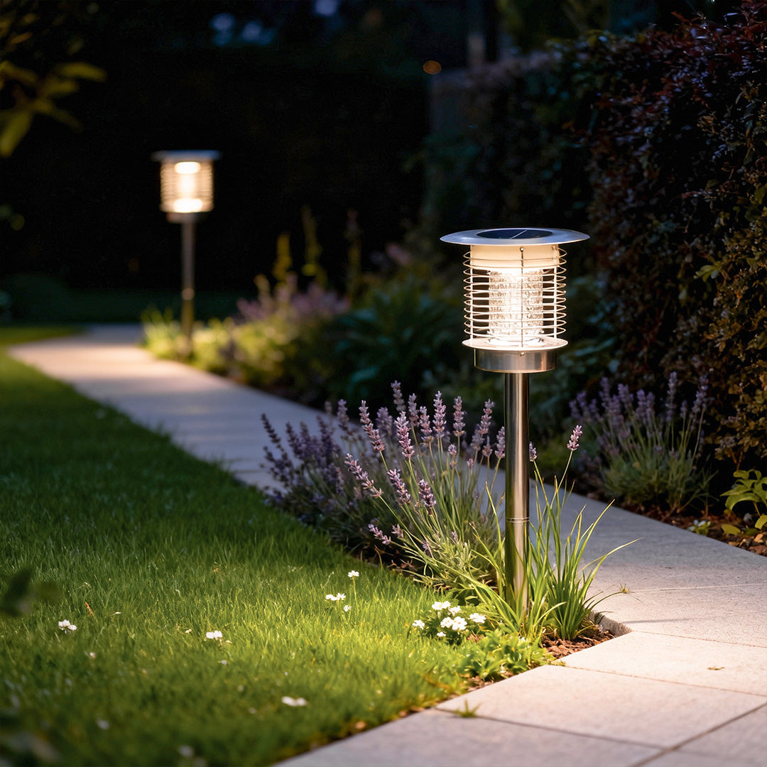 Solar light bug zapper along garden walkway providing night lighting and insect protection.