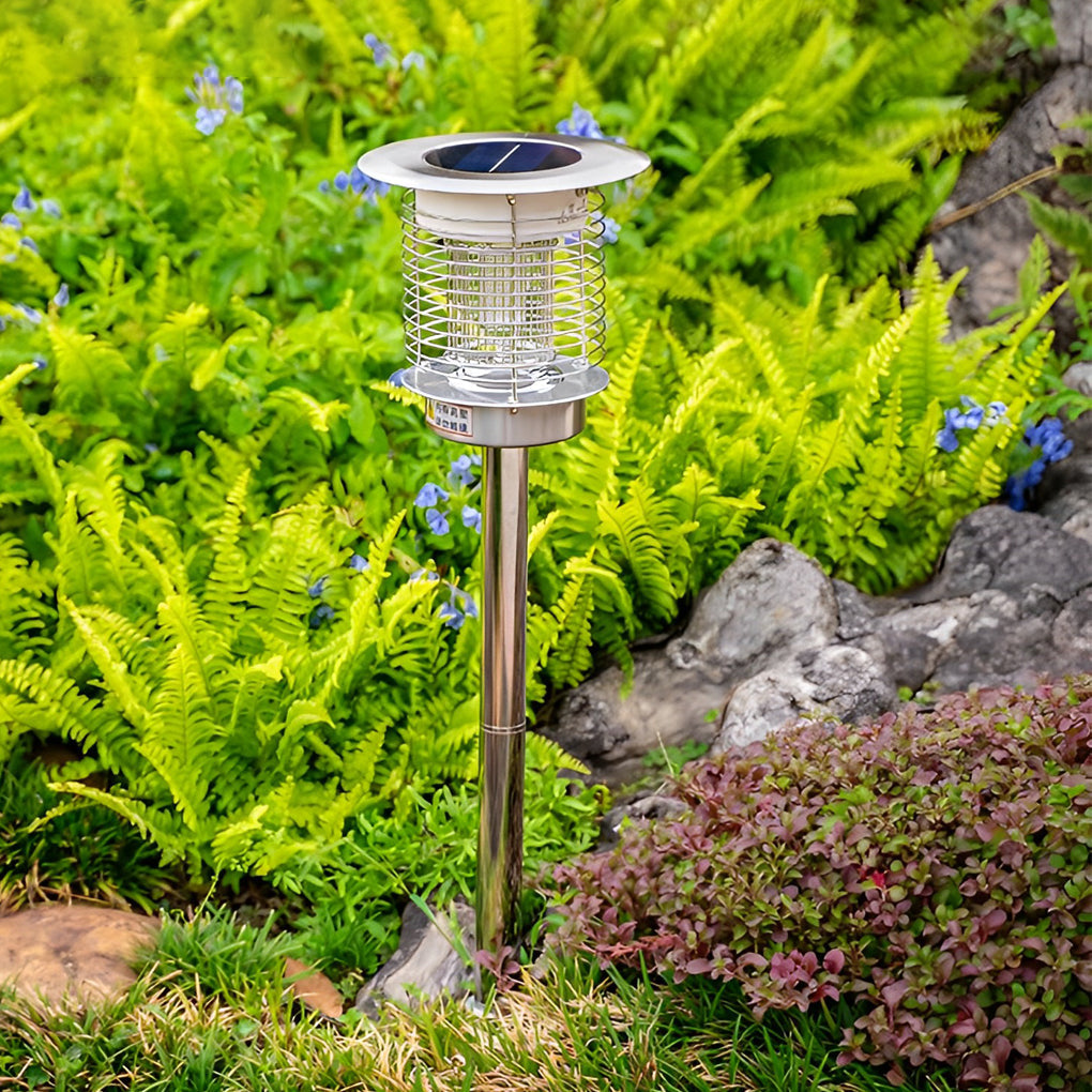 Solar light bug zapper stake light installed in grass during daytime.