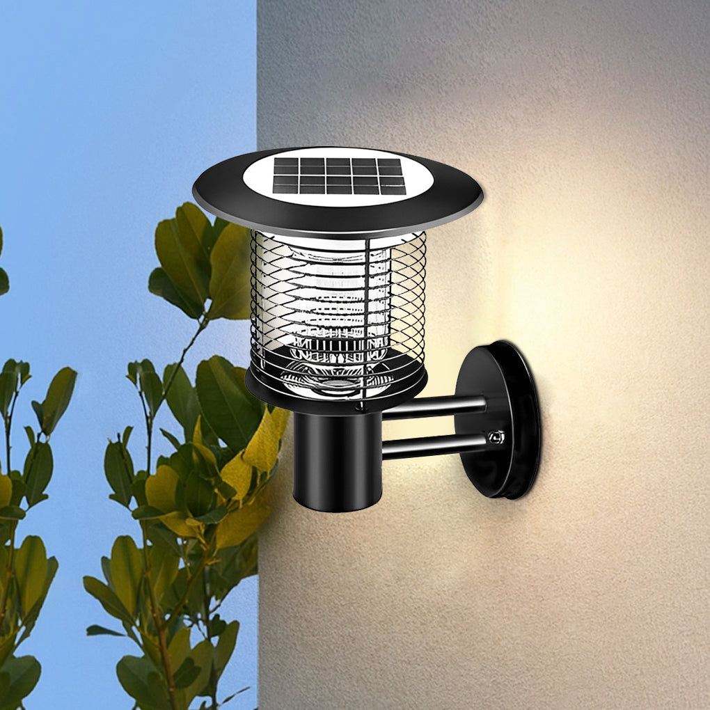Solar light bug zapper wall light installed on exterior wall with plants nearby.