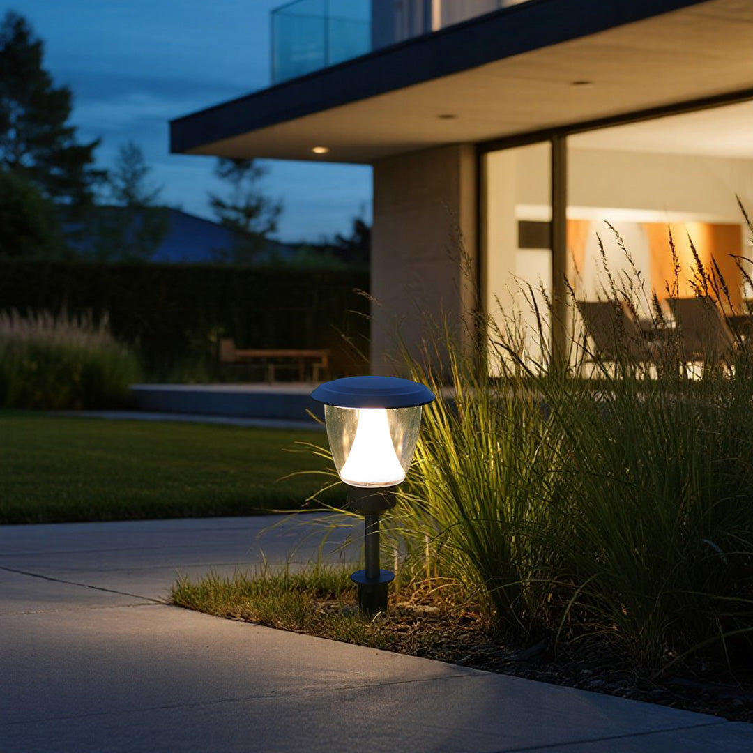Solar garden light enhancing contemporary landscape design near modern building architecture