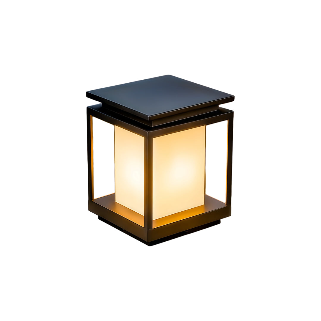 Modern solar light for main gate pillar installed on concrete entrance columns at luxury home driveway.