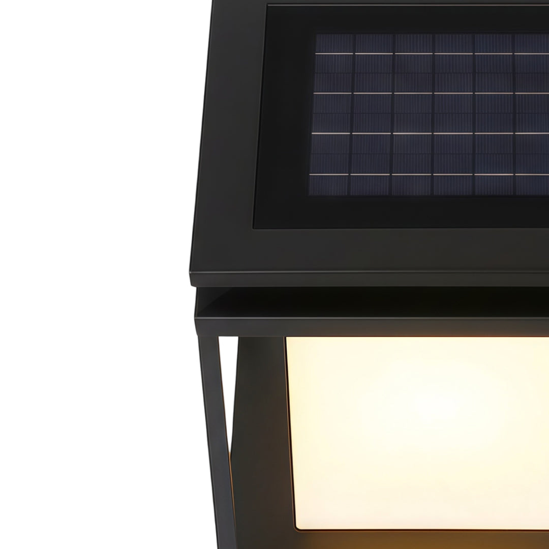 Modern solar light for main gate pillar installed on concrete entrance columns at luxury home driveway.