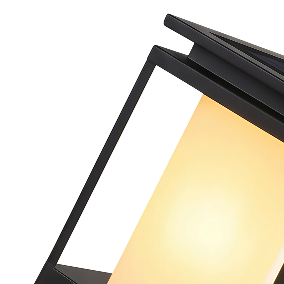 Modern solar light for main gate pillar installed on concrete entrance columns at luxury home driveway.