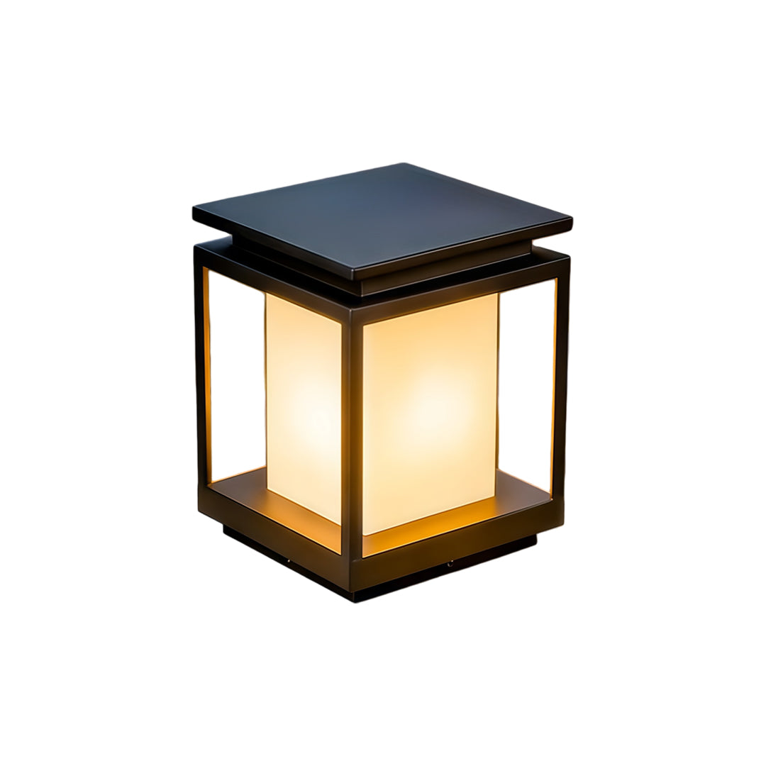 Modern solar light for main gate pillar installed on concrete entrance columns at luxury home driveway.