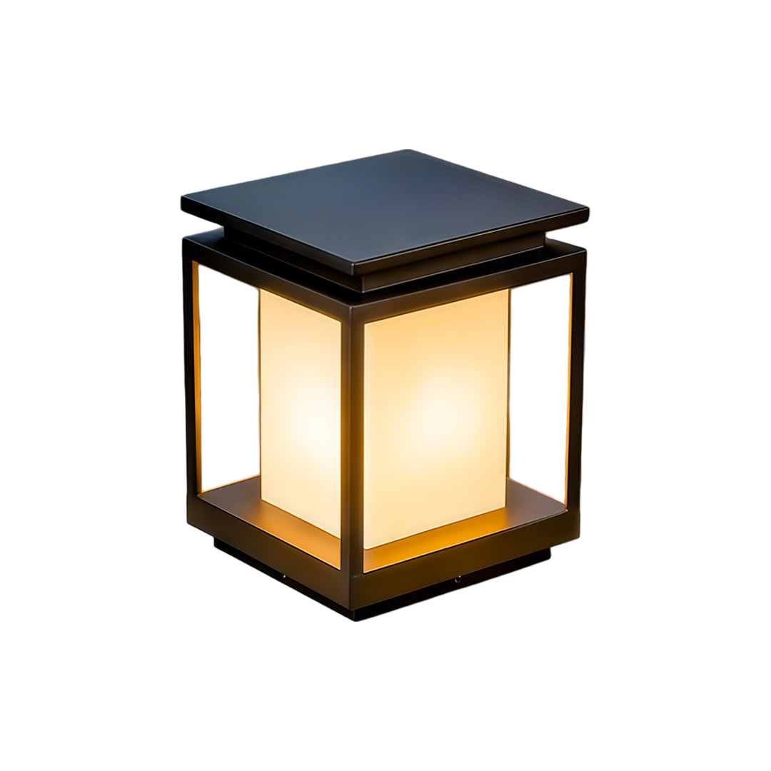 Modern solar light for main gate pillar installed on concrete entrance columns at luxury home driveway.