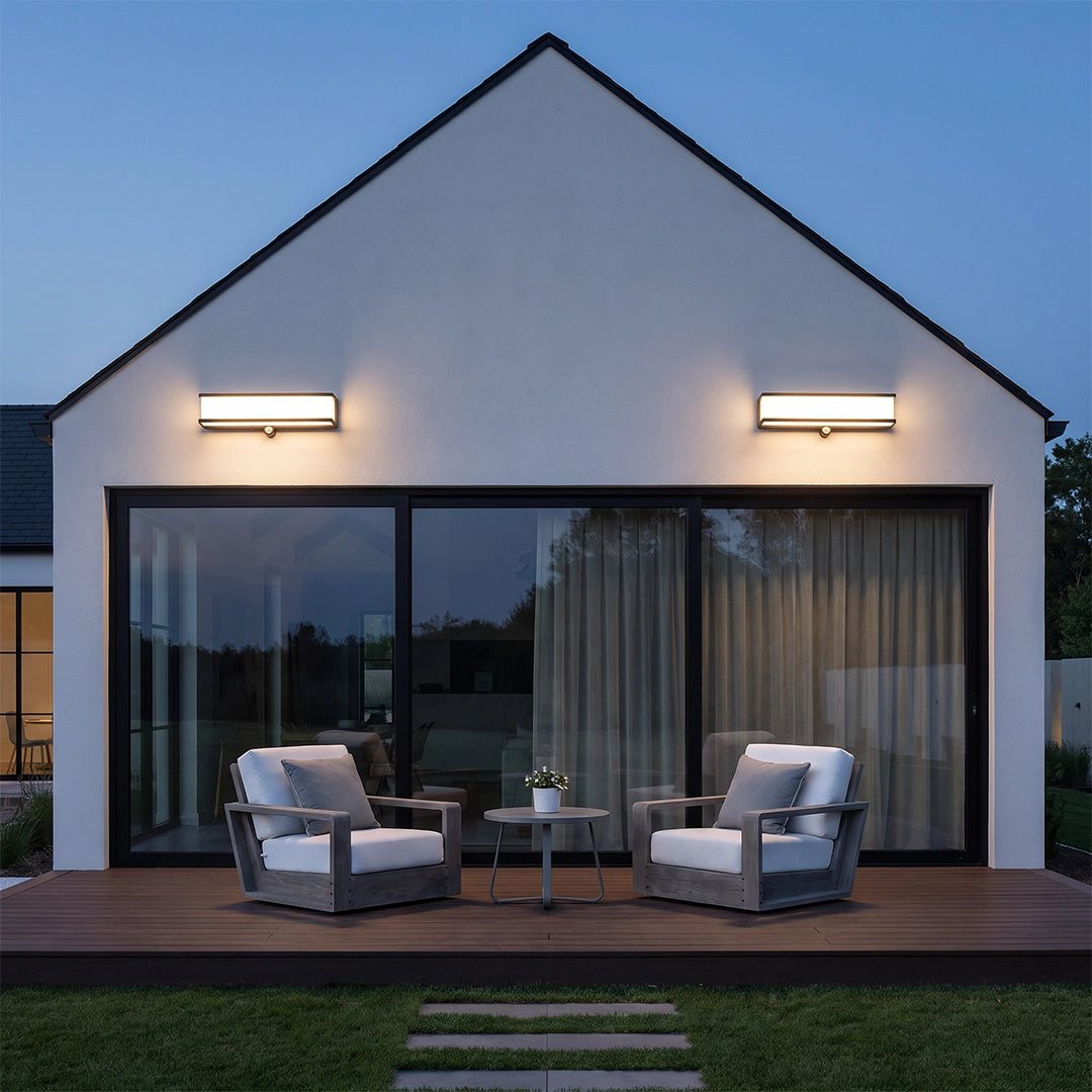 Solar light outdoor wall mount fixtures installed above patio doors on a white exterior wall.