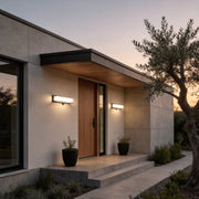 Solar light outdoor wall mount with a modern design, mounted above a wooden door.