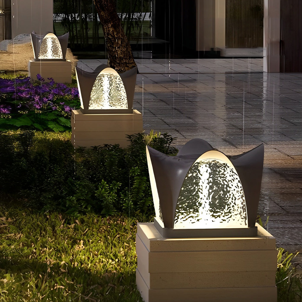 Solar light pillar with a modern design, providing ambient light near a patio.