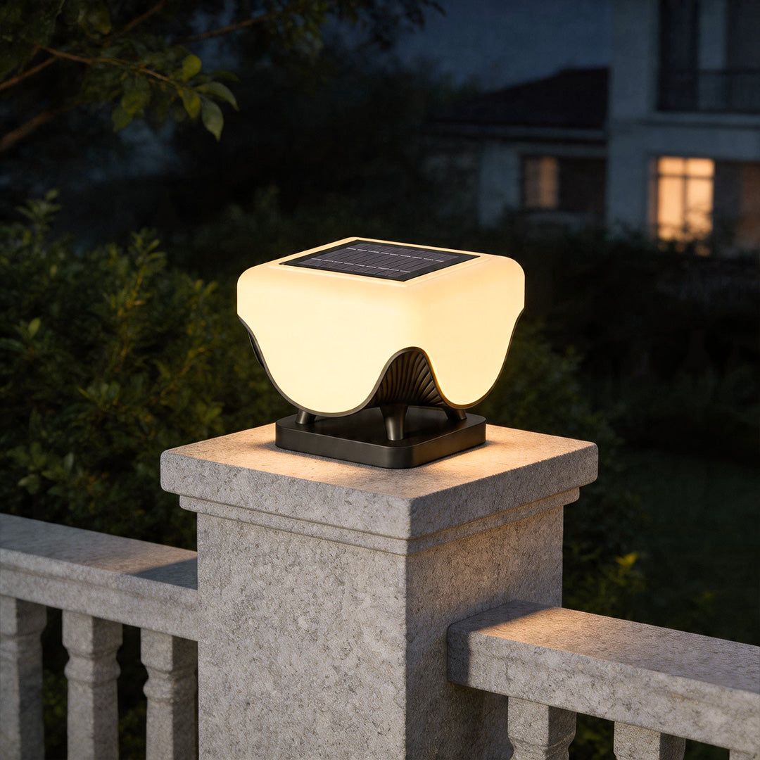 Solar lights for pillar tops installed on stone fence post with warm modern outdoor illumination.