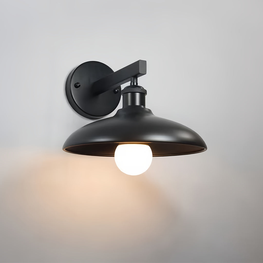 Contemporary matte-black solar lights outdoor wall fixture casting warm downward light.