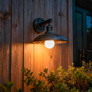 Rustic outdoor solar lights wall fixture installed on wooden exterior with warm illumination.