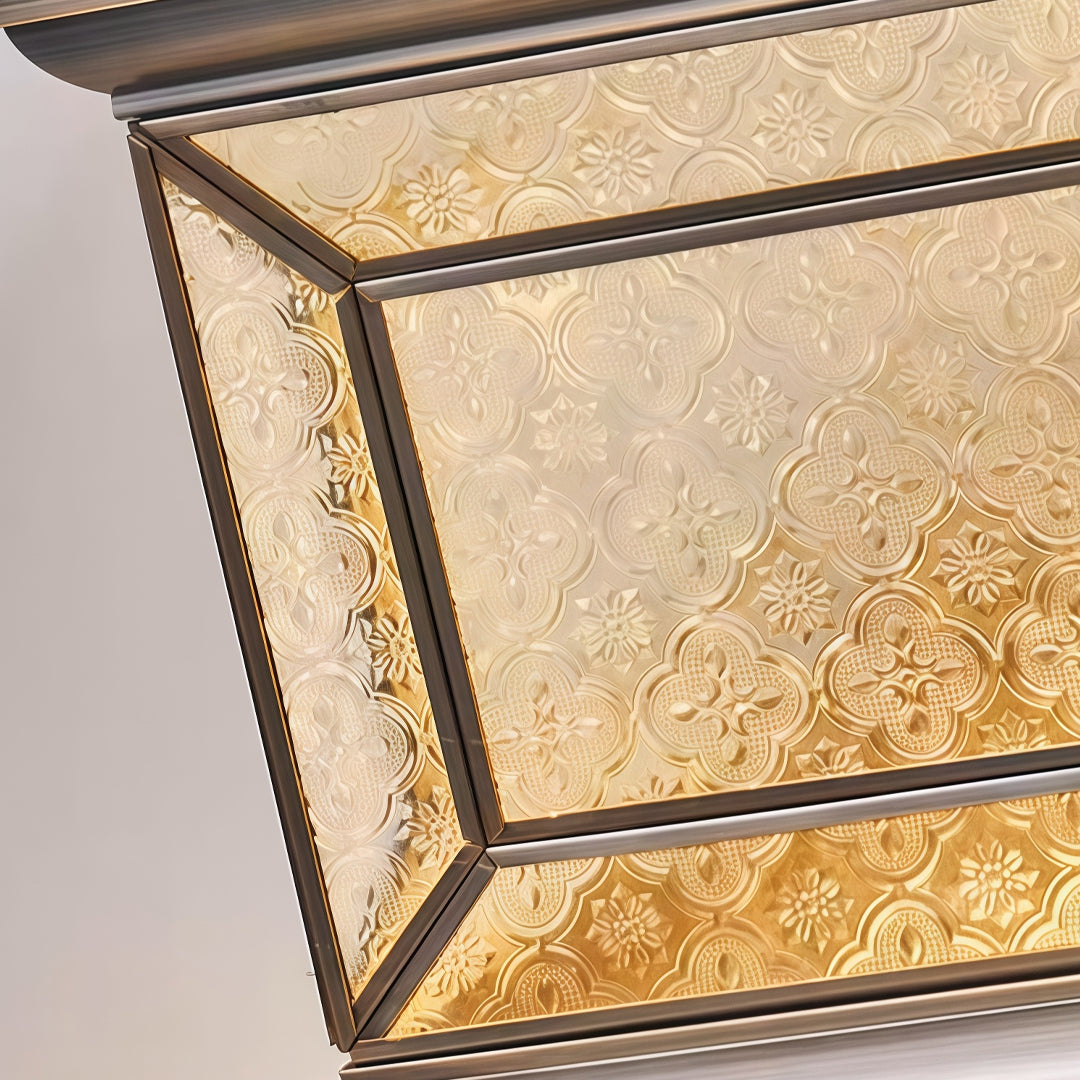 Close-up of solar lights pillar featuring textured decorative glass and bronze metal frame.