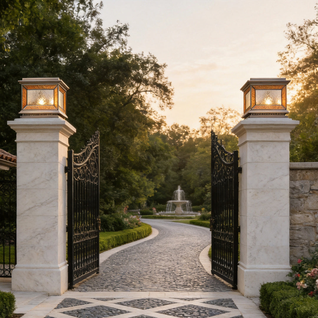 Modern solar lights pillar mounted on white gate columns along curved luxury driveway.