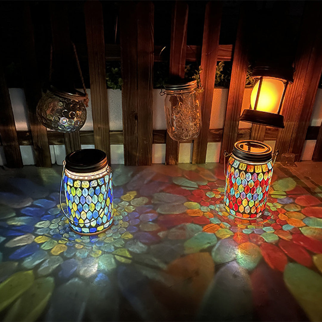 Solar mosaic lights projecting vibrant rainbow patterns with geometric shapes in darkness