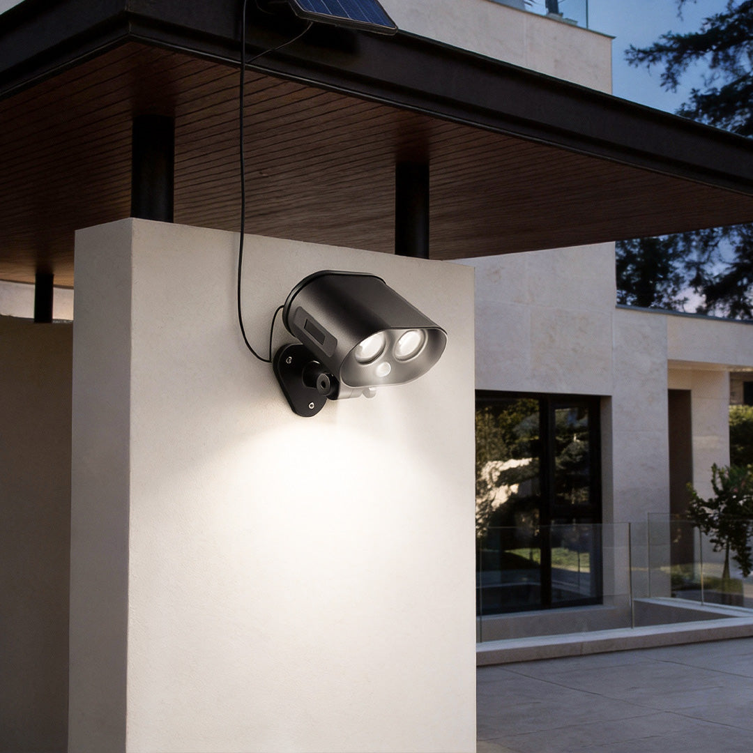 Modern house exterior illuminated by a solar motion sensor lamp mounted on an outdoor wall.