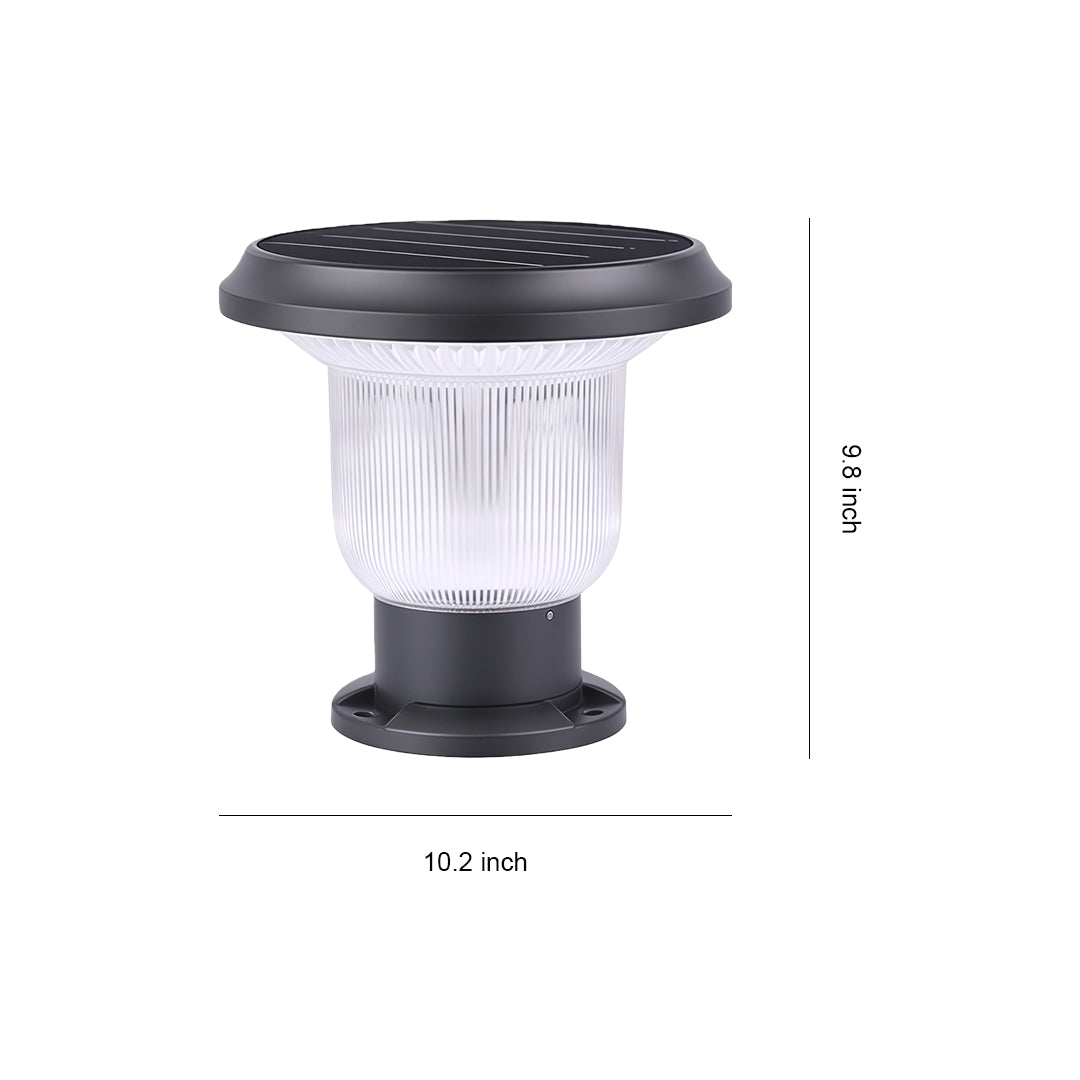 Solar-powered outdoor pillar light providing illumination along a garden fence at night.