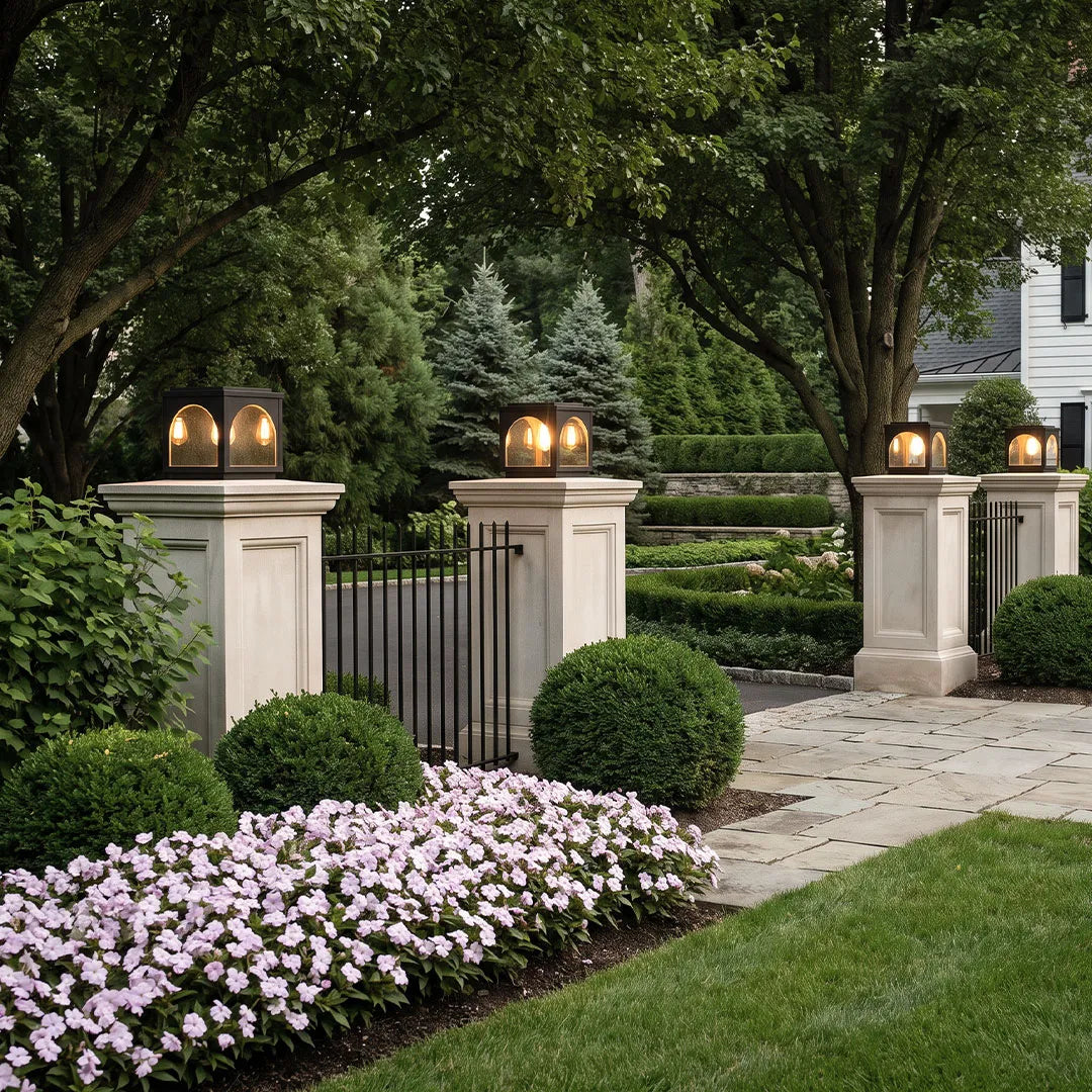 Solar outdoor pillar lights mounted on fence posts creating warm outdoor illumination.