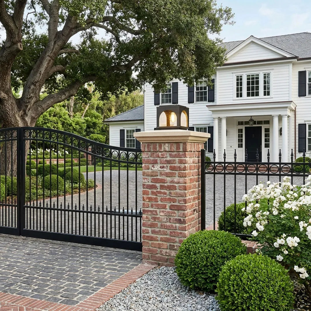 Solar outdoor pillar lights installed on landscape columns in a modern front yard.