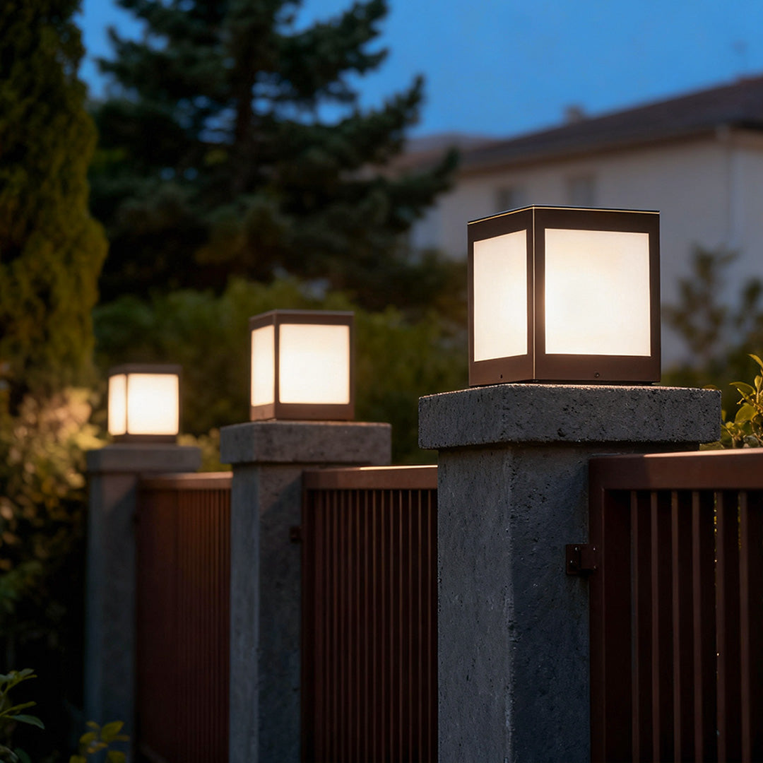 Solar outdoor pillar lights illuminating a wooden deck, creating a cozy ambiance in the evening.