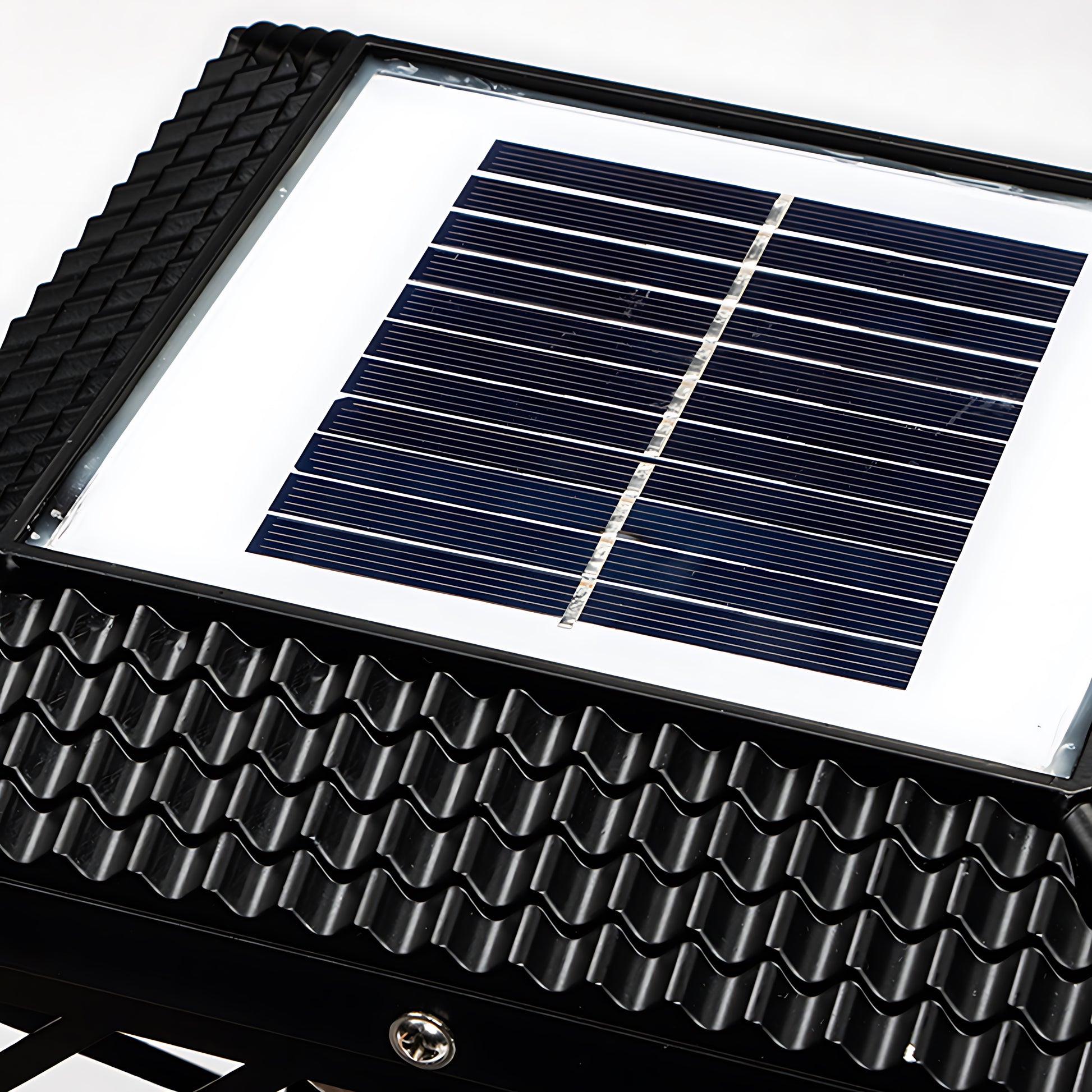 Close-up view of solar panel and lattice housing construction of outdoor light fixture