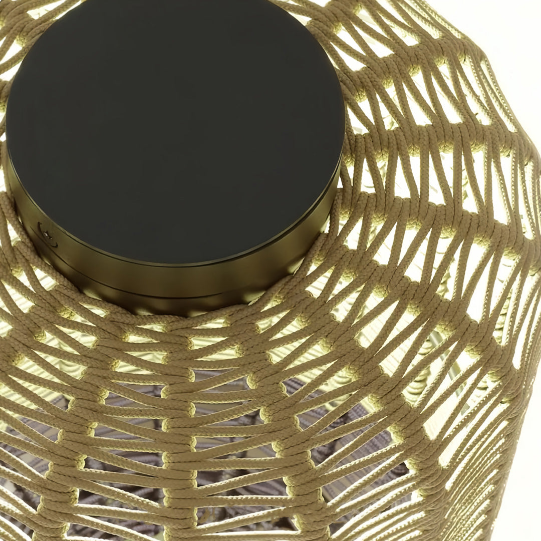 Top view of the outdoor LED lantern, highlighting the black circular solar panel and the warm internal glow of the light source.