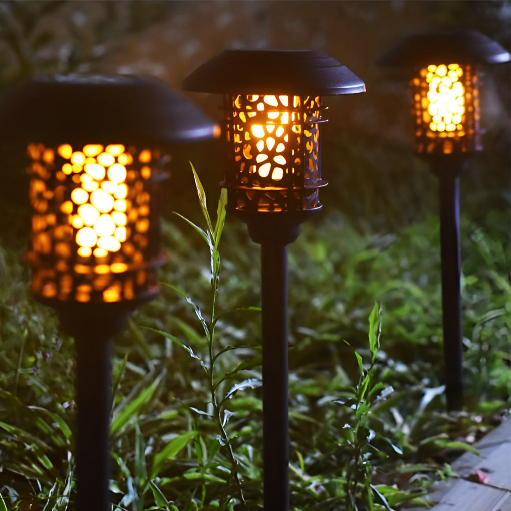 Close-up of solar path lighting LED showing decorative cutout light pattern at night.