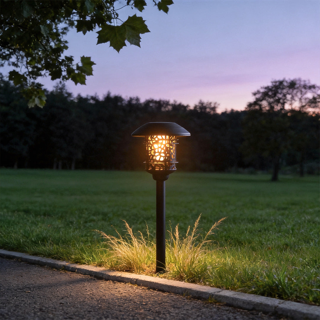 Solar path lighting LED illuminating garden lawn at dusk with warm ambient glow.