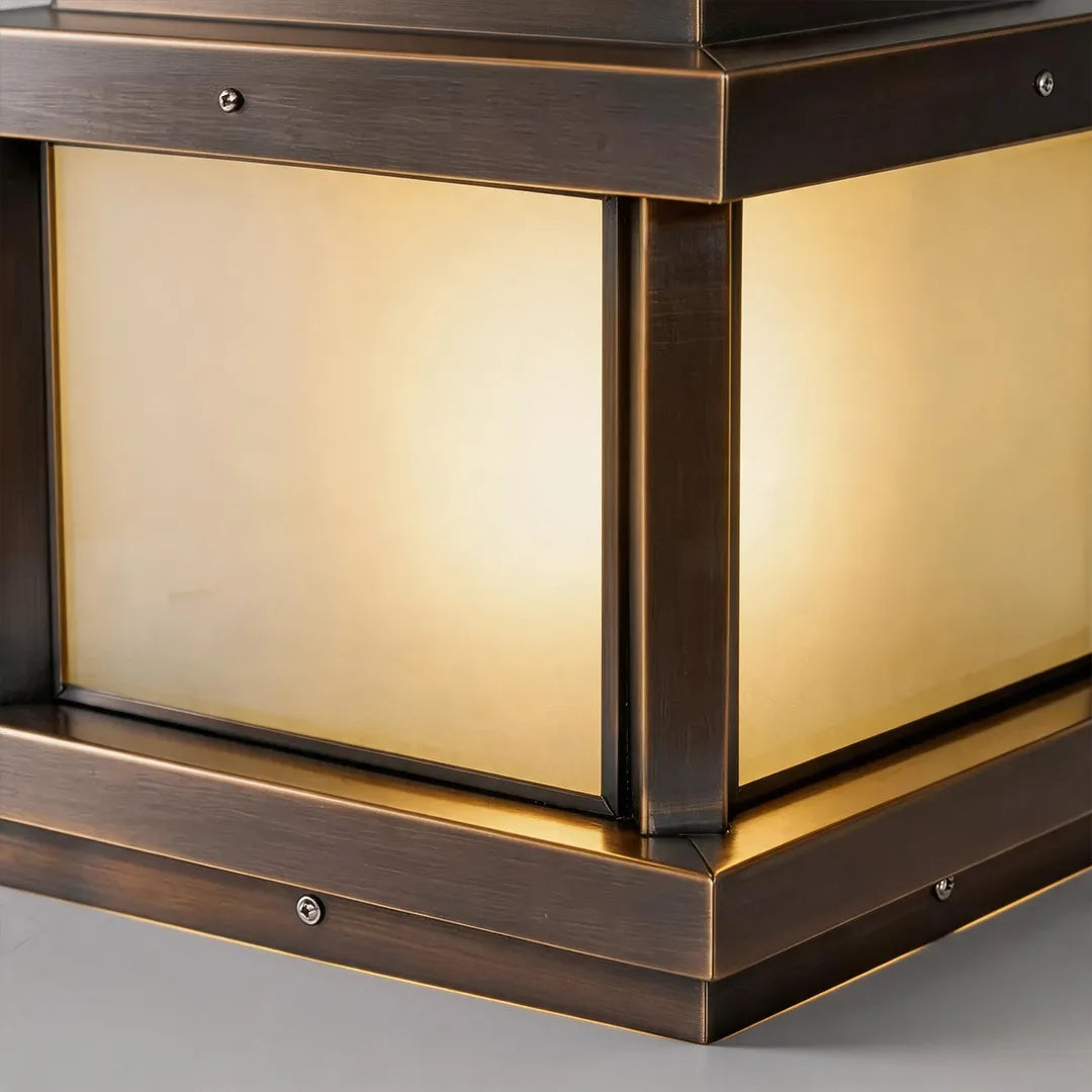 Solar pillar light with warm frosted glass and bronze metal frame detail