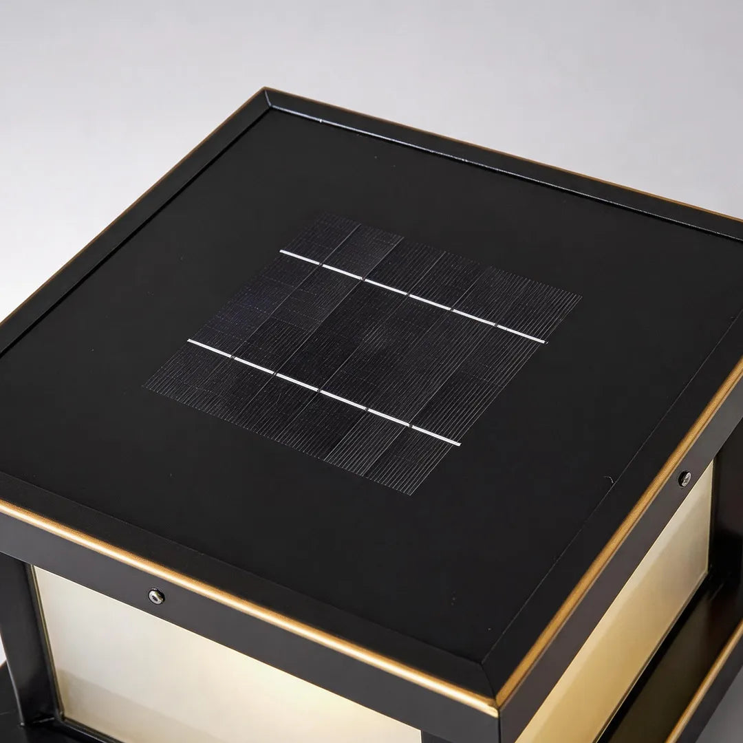 Solar pillar light with integrated top solar panel and bronze metal frame detail
