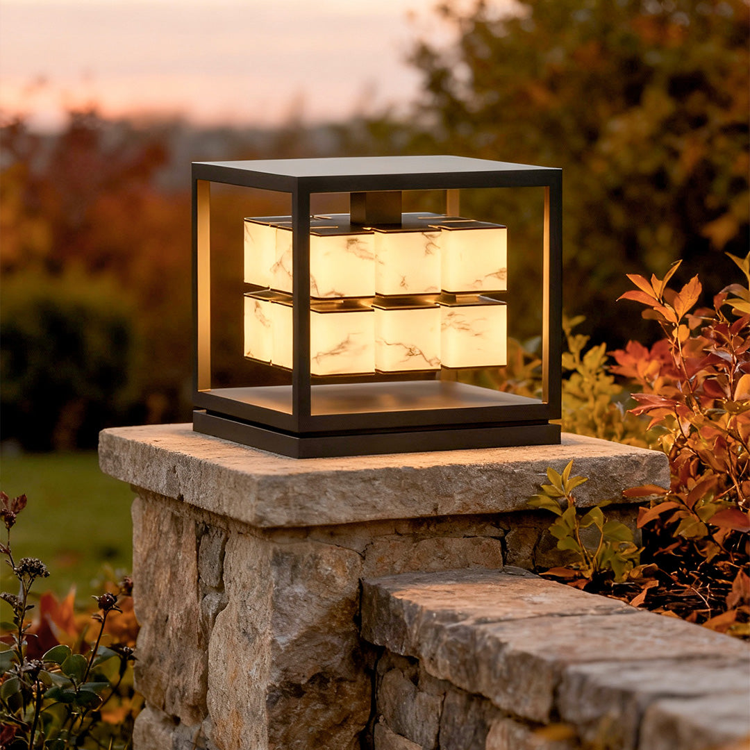 Solar pillar light mounted on stone column at dusk