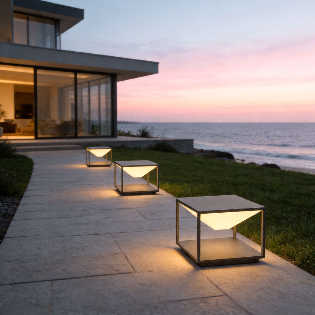 Solar pillar light outdoor illuminating seaside pathway with warm decorative exterior lighting style.