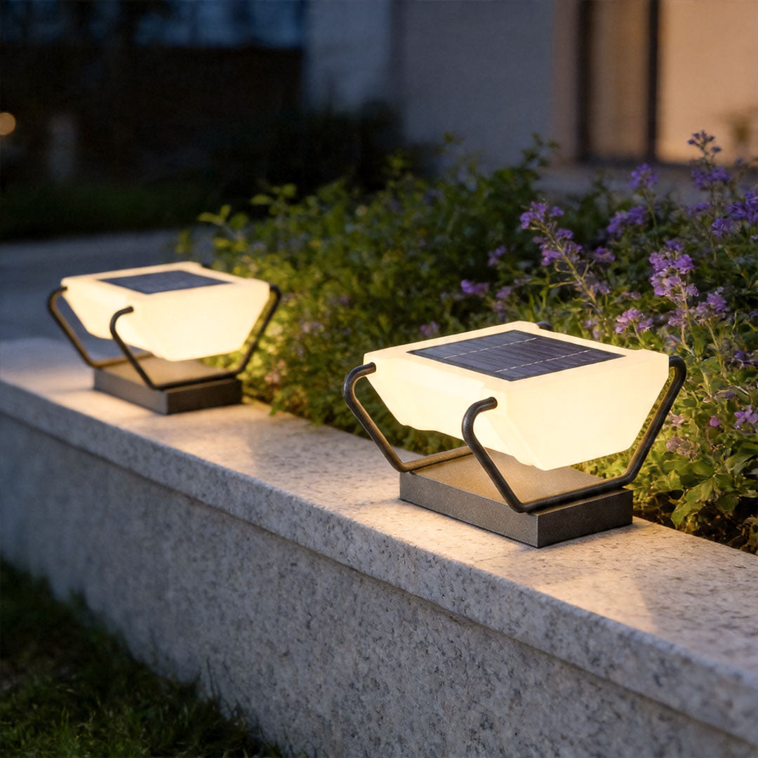 Solar pillar lighting installed on modern garden wall with warm decorative outdoor illumination.