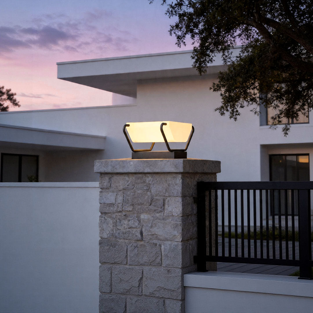 Solar pillar lighting mounted on stone entrance column creating elegant evening outdoor ambiance.