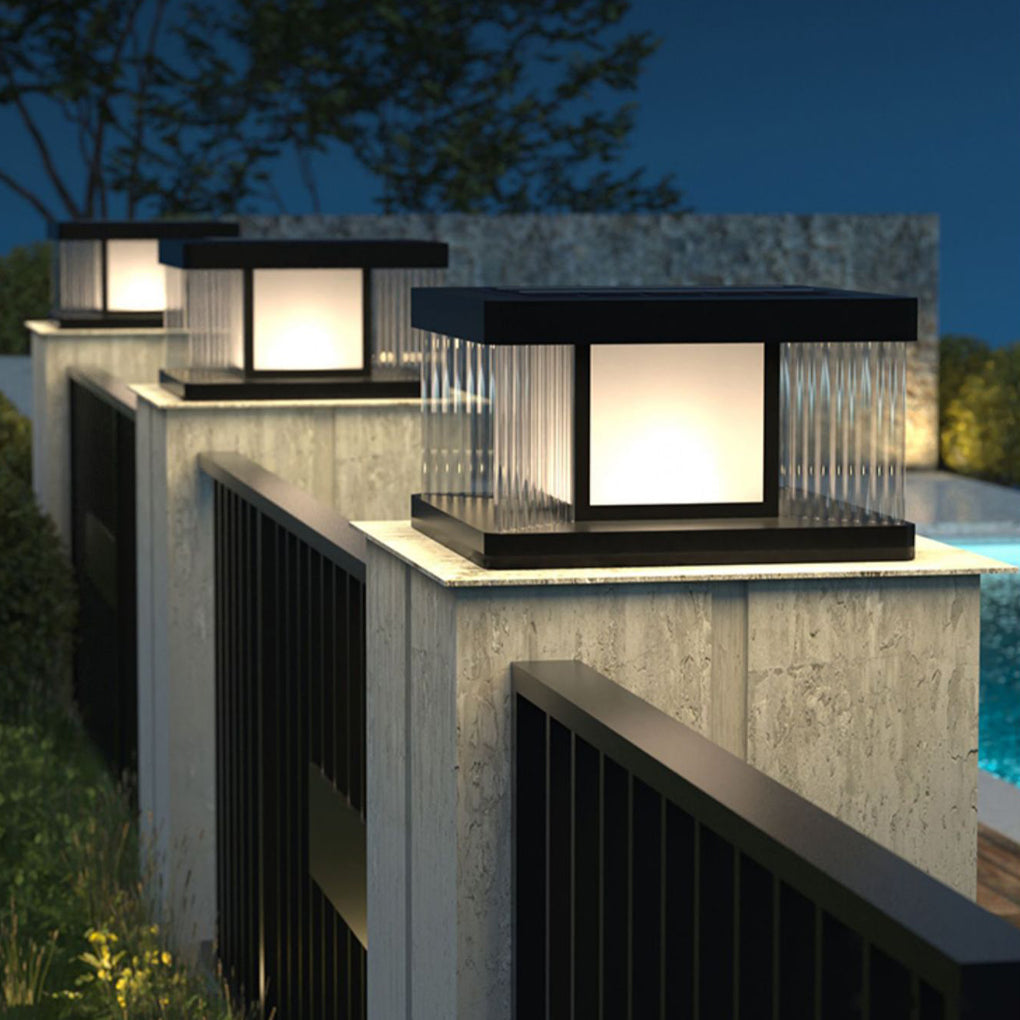 Solar pillar lights with a black finish, enhancing a contemporary outdoor setting.