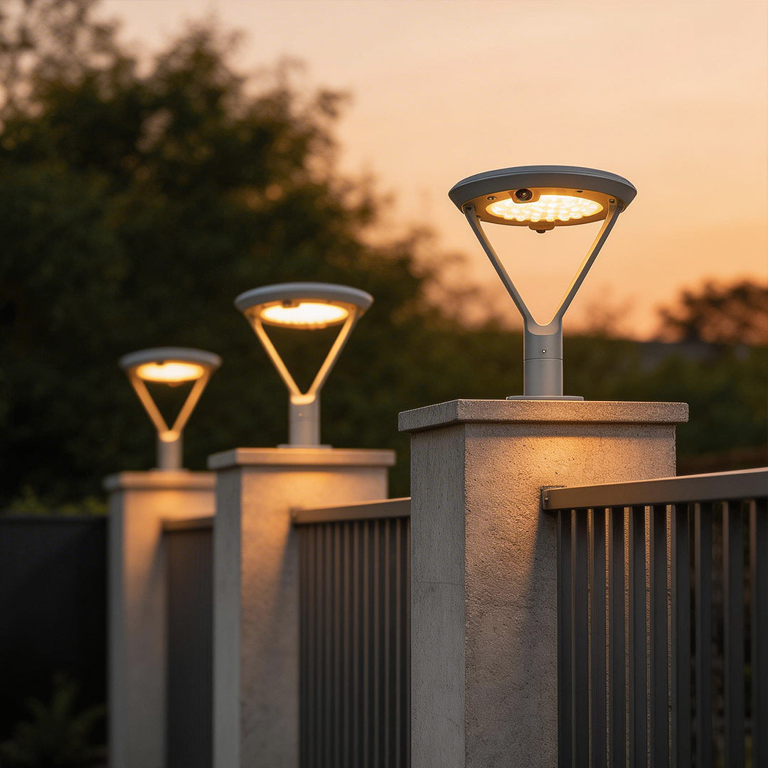 Solar pillar lights with a close-up of their illuminated top and solar panel.