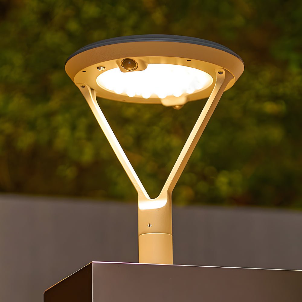 Solar pillar lights with a sleek design, providing warm light along a pathway.